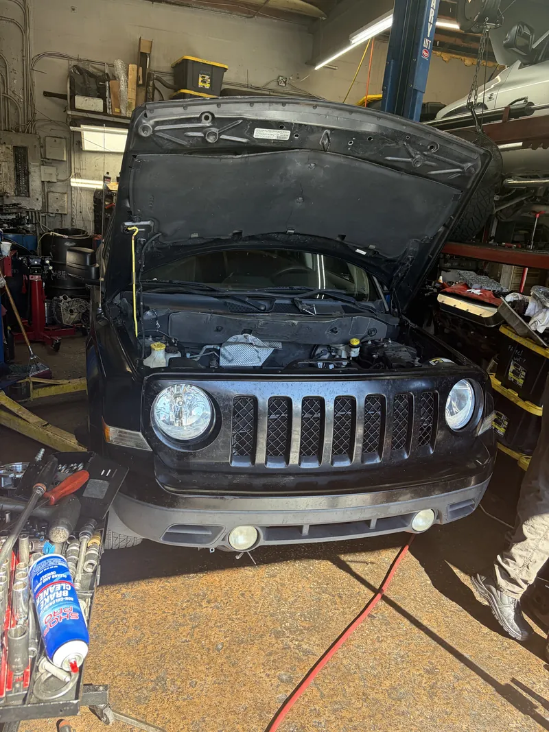 Jeep on the lift with the hood open
