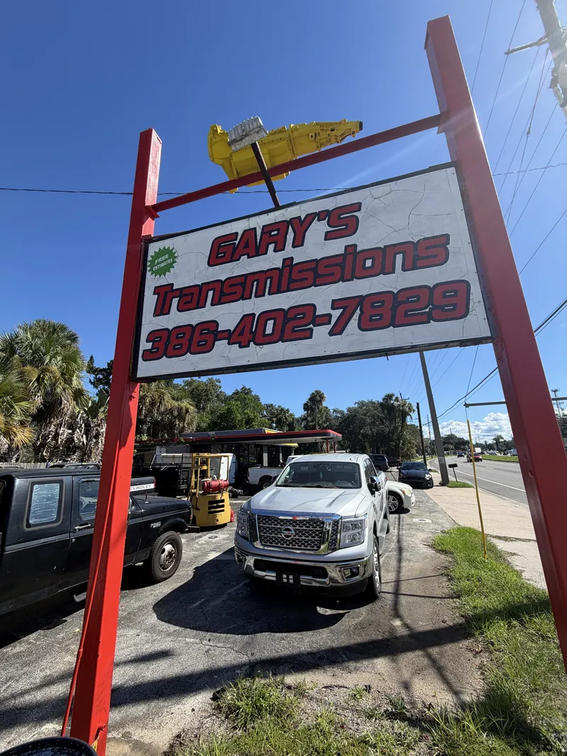 Close-up of the Gary's Transmissions sign showing the phone number 386-402-7829