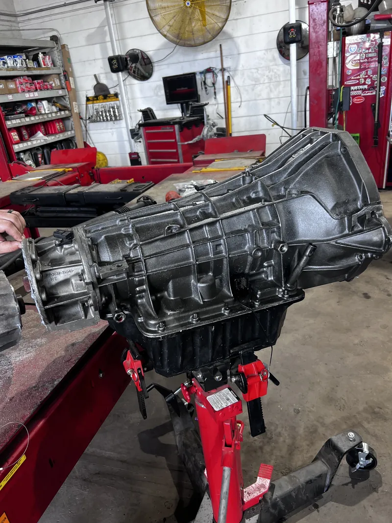 Heavy-duty transmission supported on a jack inside the shop