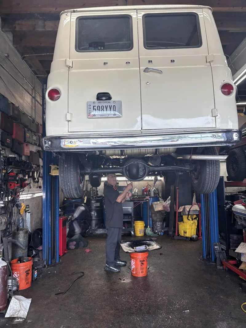 Classic van on the lift while a technician works underneath
